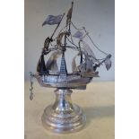 An early 20thC silver coloured metal model, a triple masted galleon with sails and rigging,