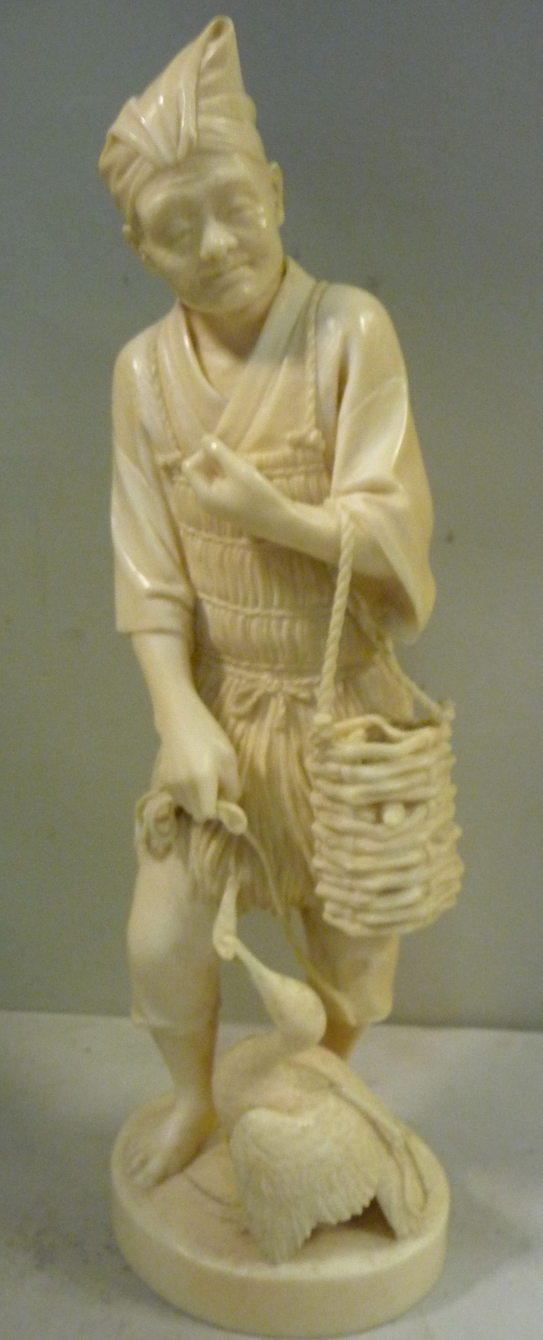 A 19thC Japanese carved ivory standing figure,