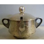 An early 20thC Continental silver coloured metal twin handled conserve pot and cover with a