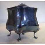 An Edwardian silver tea caddy of waisted, oval form with a domed,