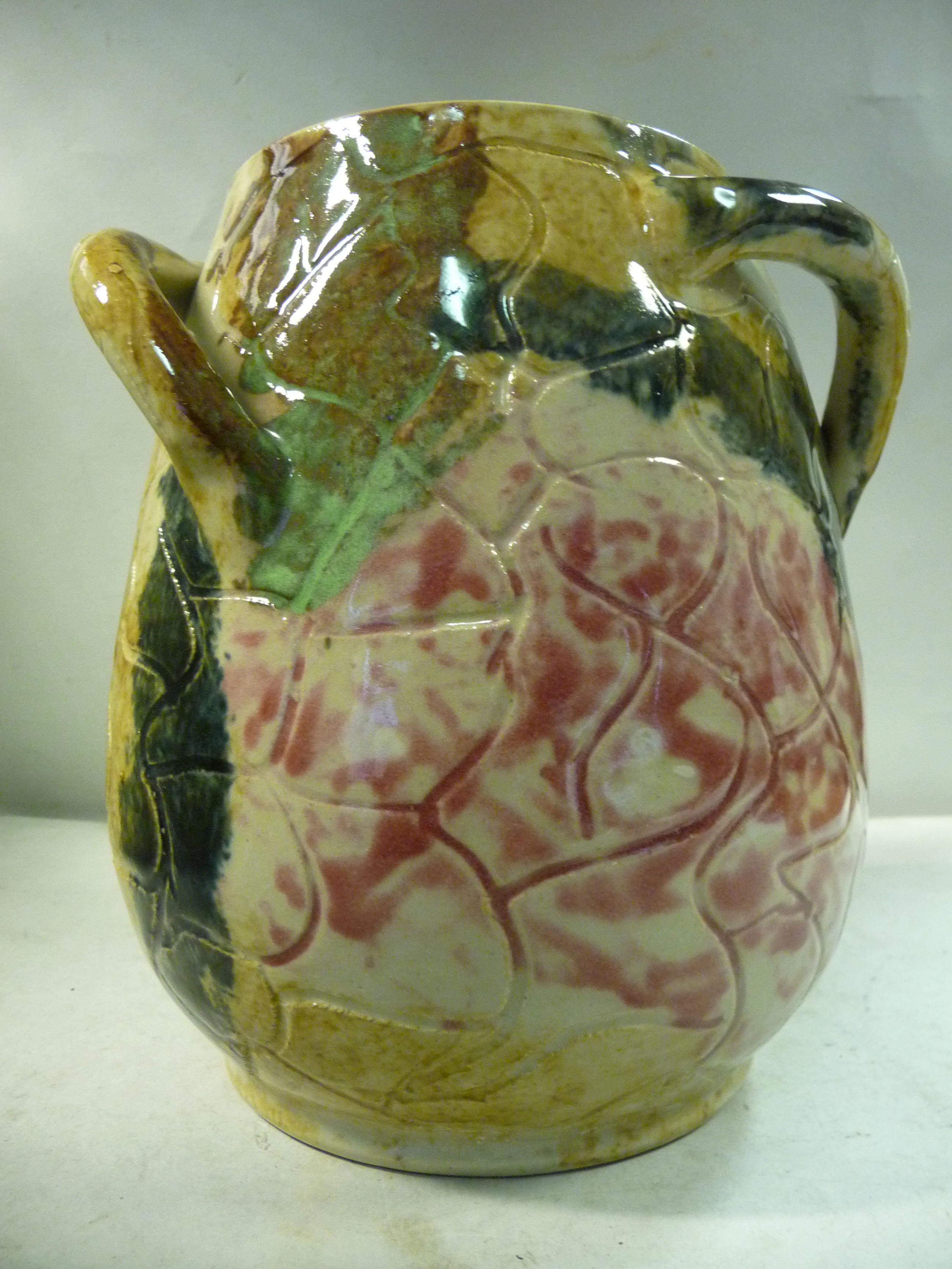 A Fulham Pottery Hurlingham Ware multi-coloured glazed vase of ovoid form with two strap handles