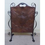 An Arts & Crafts wrought iron framed firescreen with a spot-hammered copper panel,