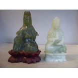 Two similar Oriental carved green jade figures, both seated, crosslegged 4.