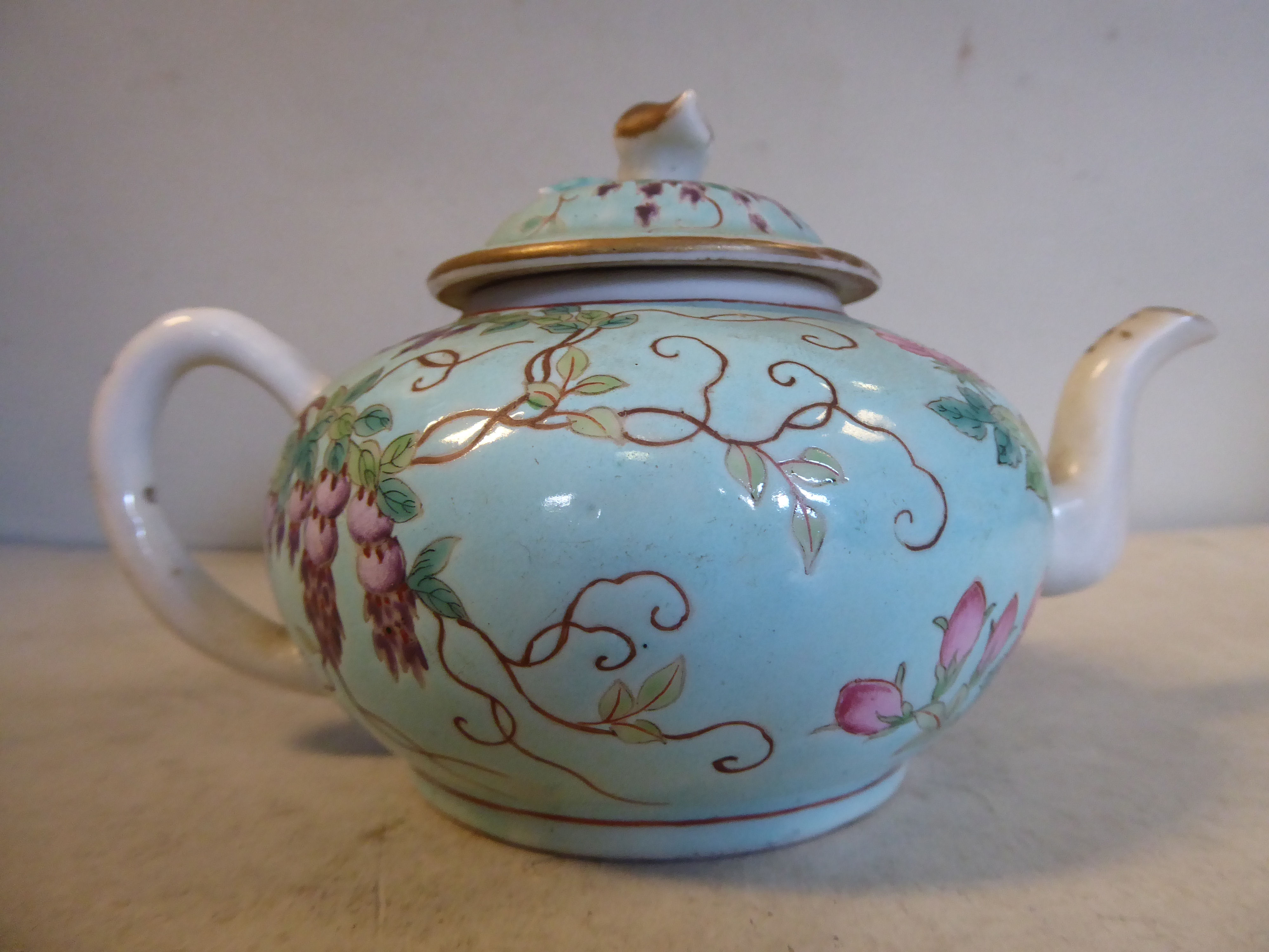 A late 19thC Chinese porcelain 'small' teapot of squat, bulbous form with an S-shaped spout,