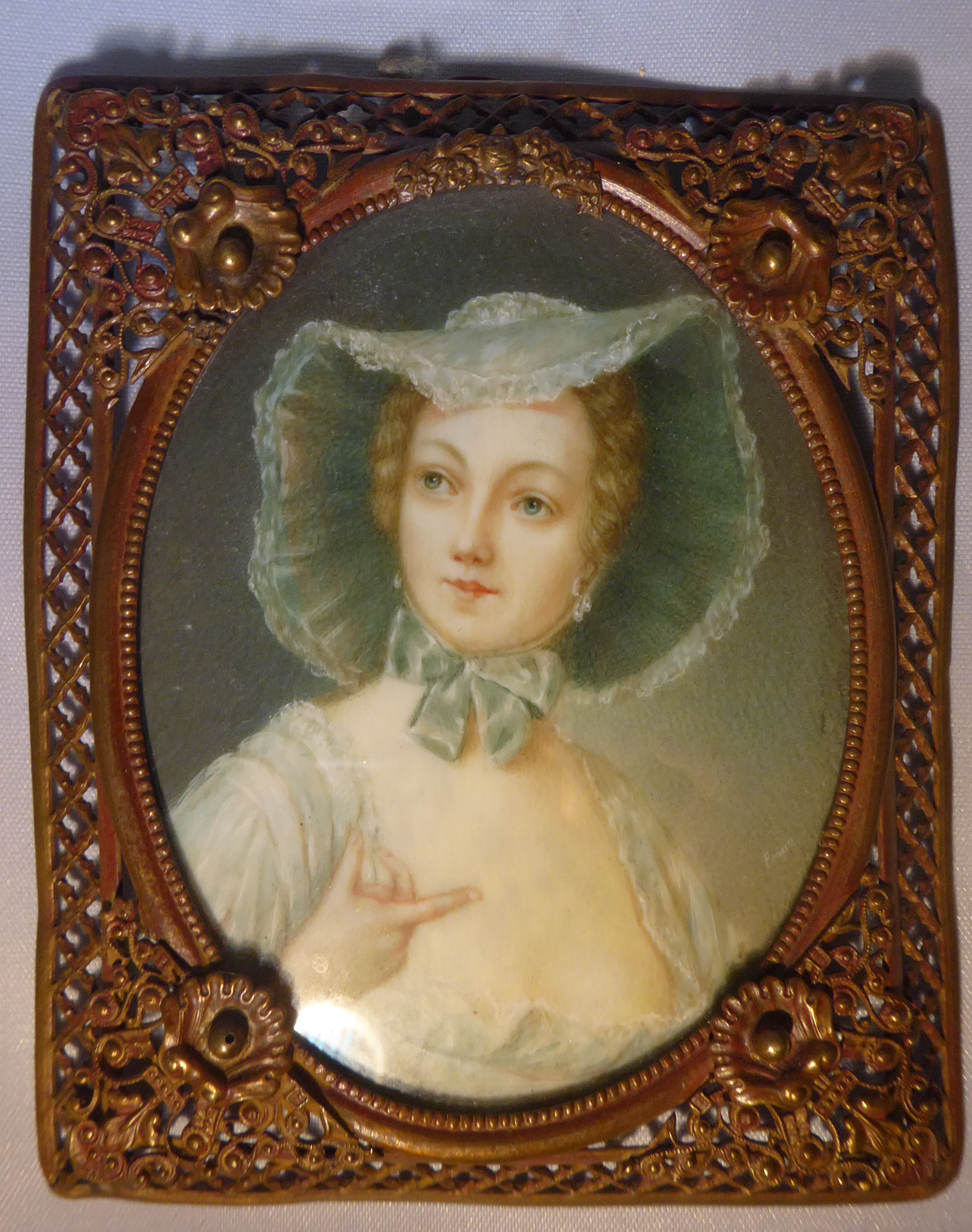 A late 19thC portrait miniature, a woman wearing a bonnet and dress watercolour on ivory 3.