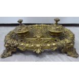 A late 19th/early 20thC ornately cast, lacquered brass deskstand,