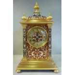 A 20thC lacquered brass cased mantel clock,