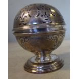 An 18thC style embossed silver soap box of spherical form with a decoratively pierced, hinged cover,