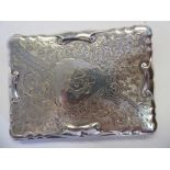 An Edwardian silver folding card/notelet case with scroll moulded borders and bright-cut engraved