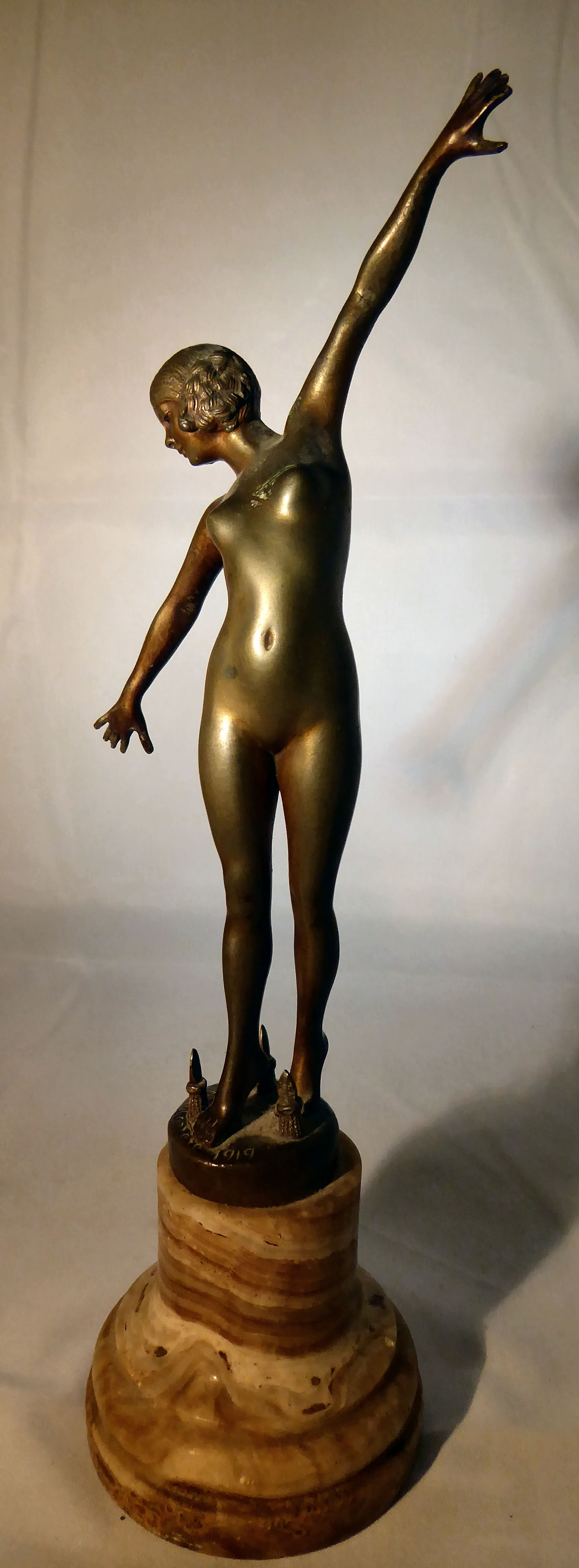 F Ouillon Carrere - 'Sword Dance' a gilt bronze figure bears a signature & dated 1919,