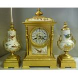 An early 20thC Continental cast gilt metal and cream glazed china cased clock garniture,