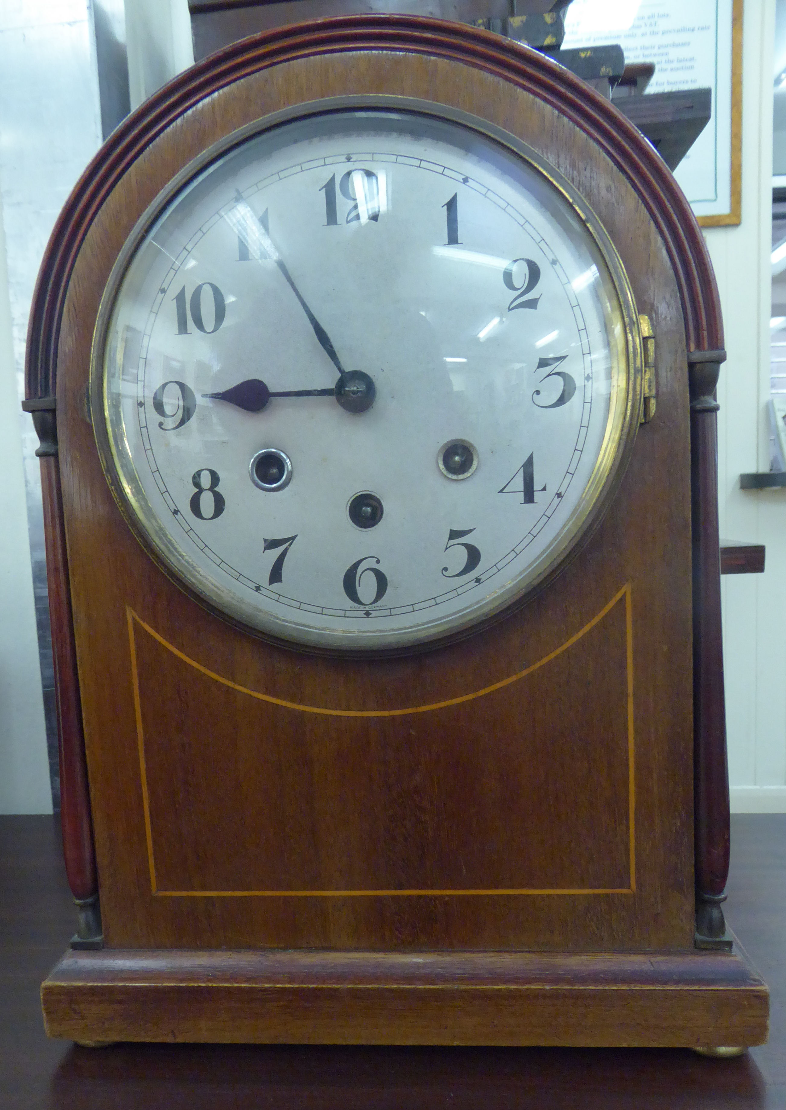 An Edwardian mahogany cased lancet topped bracket clock with string inlaid ornament and pillared