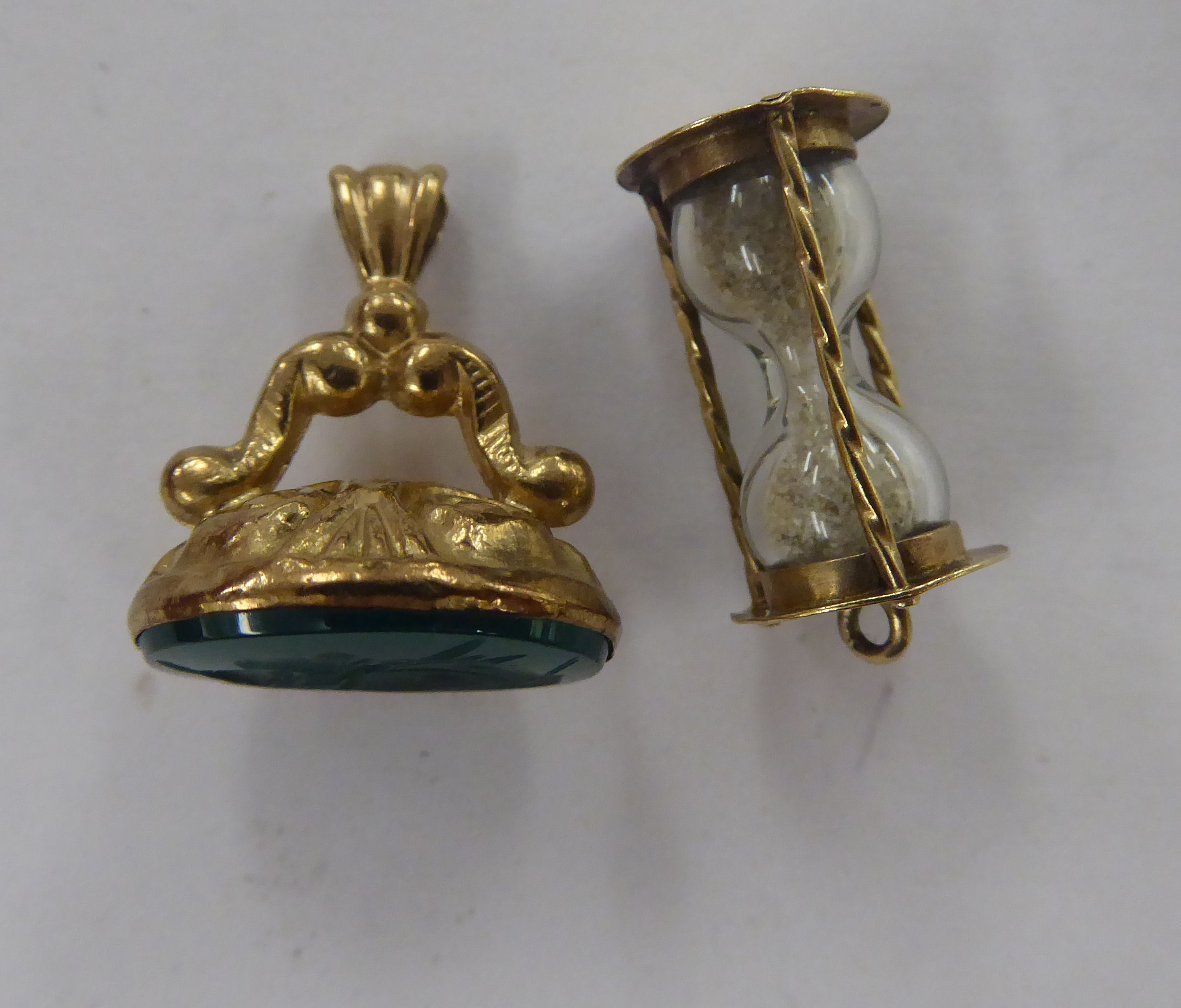 A gold coloured metal pendant seal; and a 9ct gold charm,