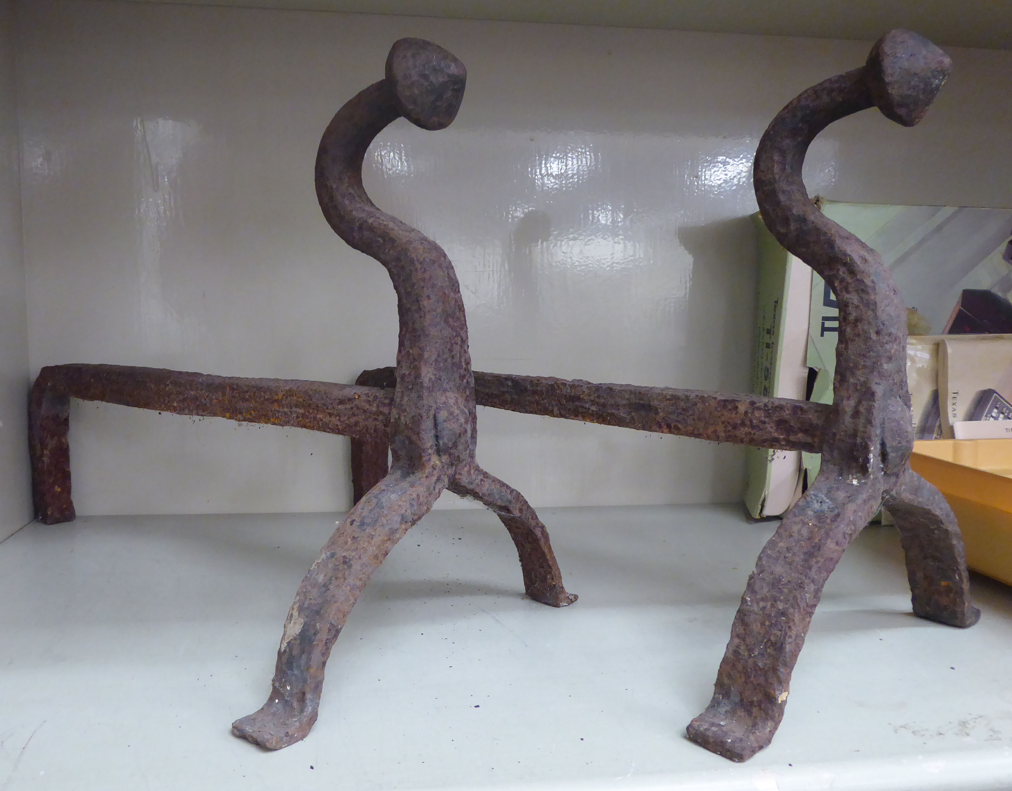 A pair of late 18thC wrought iron fire dogs,