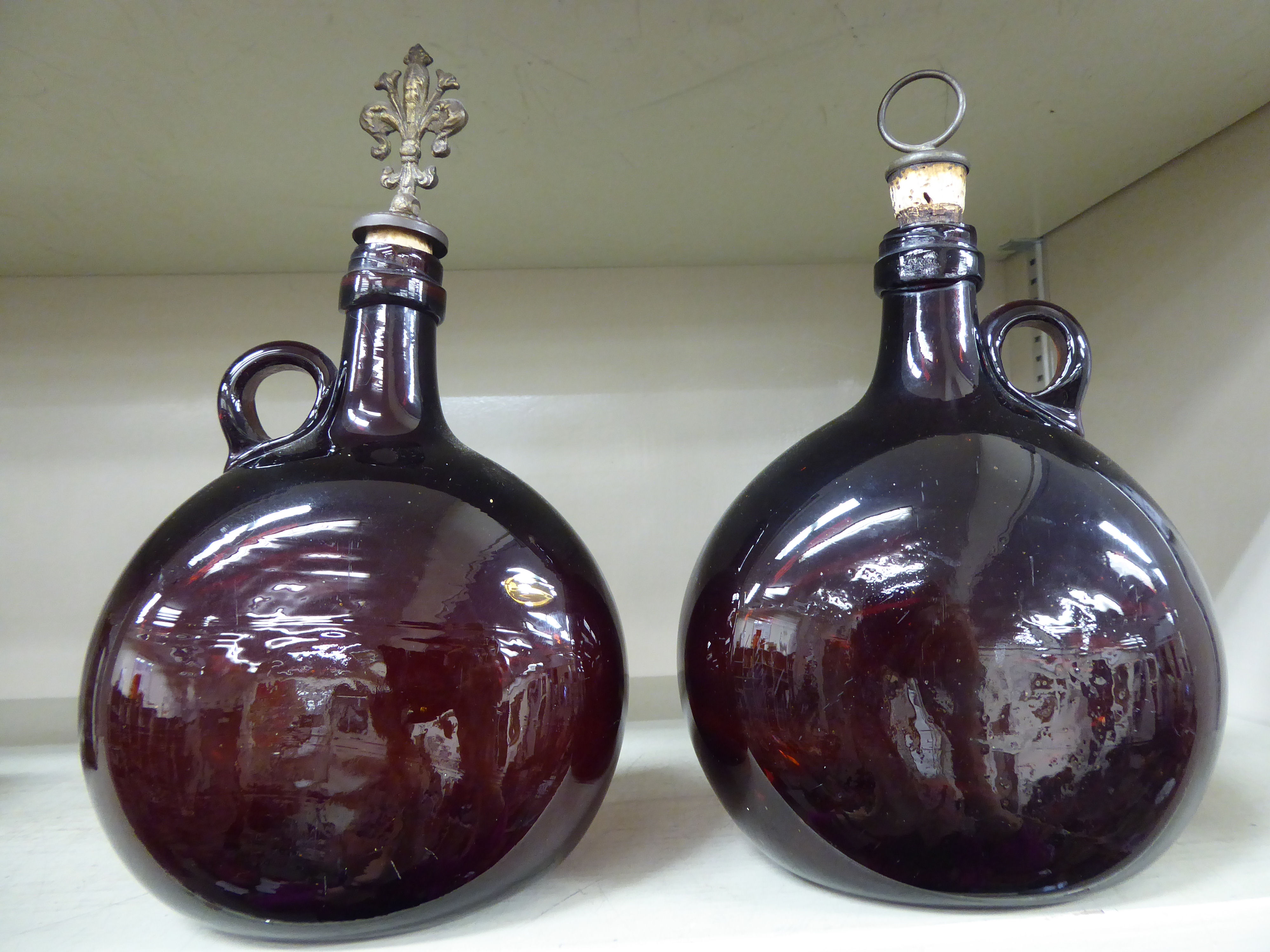 A pair of late 19thC semi-opaque amber coloured glass flasks of flattened, bulbous form,