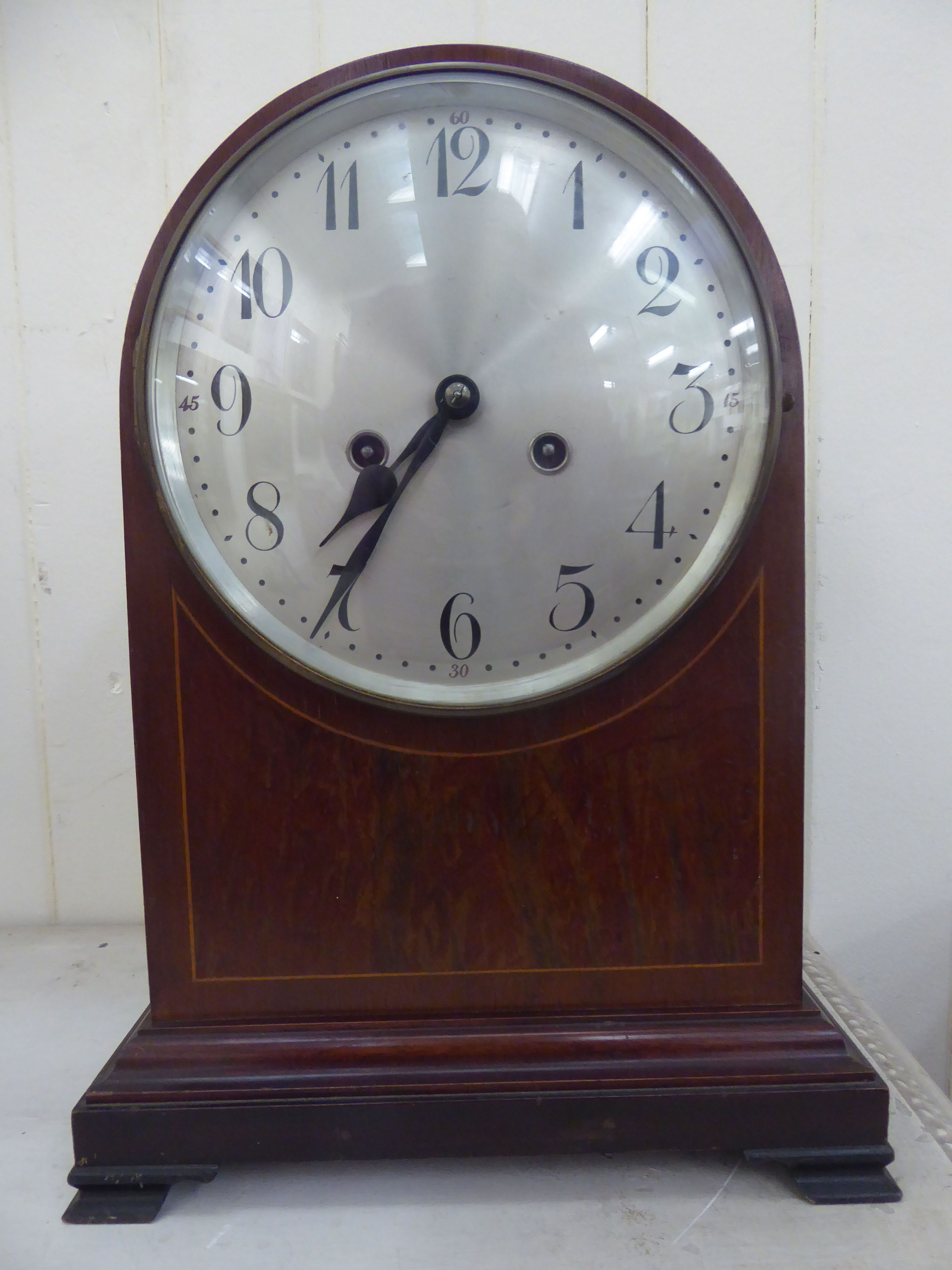 An Edwardian mahogany cased lancet topped bracket clock with string inlaid ornament,