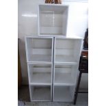 An arrangement of white painted cube design, open front, stacking display shelves,