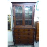 A William IV mahogany cabinet bookcase, the upper part enclosed by a pair of glazed panelled doors,