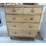 An early 20thC waxed pine dressing chest,