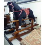 A mid 20thC Pegasus black and white fur fabric covered nursery rocking horse,