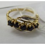 A 9ct gold sapphire and diamond set crossover ring 11