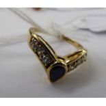 A 9ct gold wishbone design ring, set with a central sapphire,
