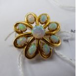 A gold coloured metal brooch,