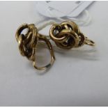 A pair of gold coloured metal earrings with C-scrolled and crossover ornament 11