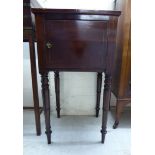 An early 19thC satinwood string inlaid mahogany pot cupboard with a galleried top, over a door,