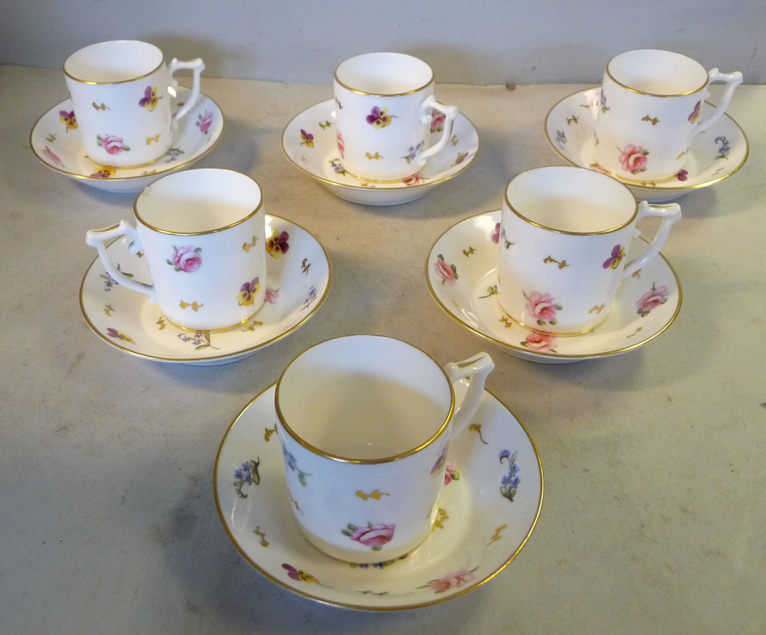 A set of six Derby, Stevenson & Hancock china coffee cans and saucers,