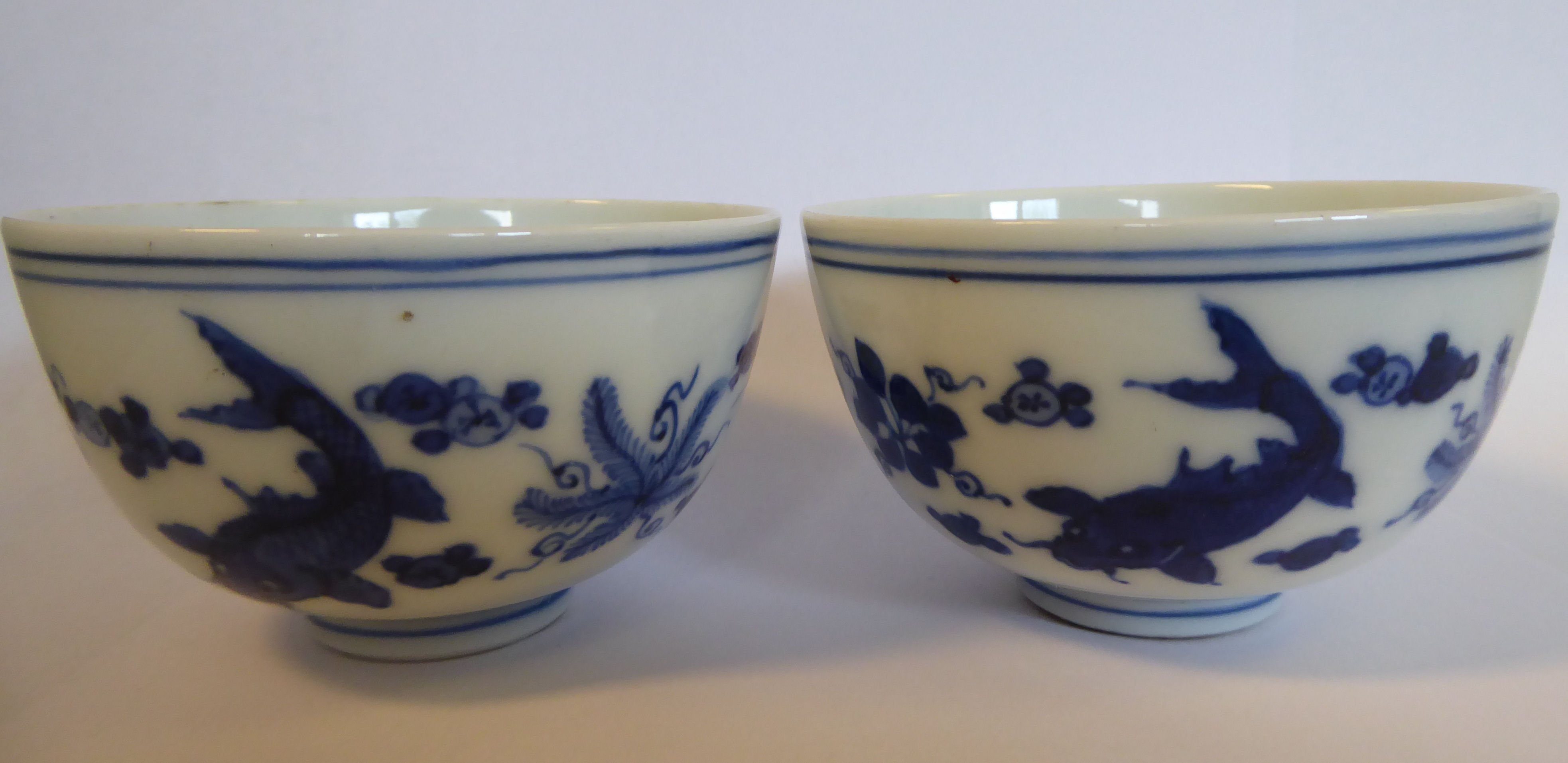 A pair of late 19th/early 20thC Japanese porcelain tea bowls, decorated in blue and white with carp, - Image 3 of 8