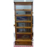 An early 20thC Globe Wernicke light oak cabinet bookcase with fielded panelled flanks and outset,
