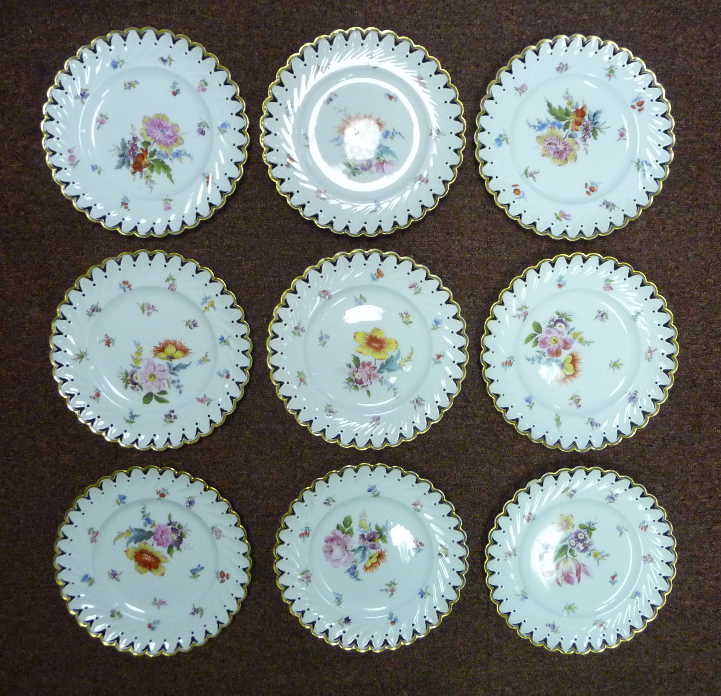 A set of nine early 20thC Continental ivory glazed porcelain dessert plates with thumb moulded, - Image 2 of 11