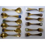 A set of six Georg Jensen silver gilt year spoons and forks,