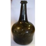 An 18thC mallet shaped semi-opaque dark green glass bottle with a tapered neck,