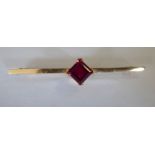 A gold coloured metal bar brooch,