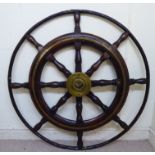 An 'antique' stained oak and beech ship's wheel with baluster turned spokes,