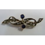 A late Victorian white metal brooch of crossover, free flowing form,