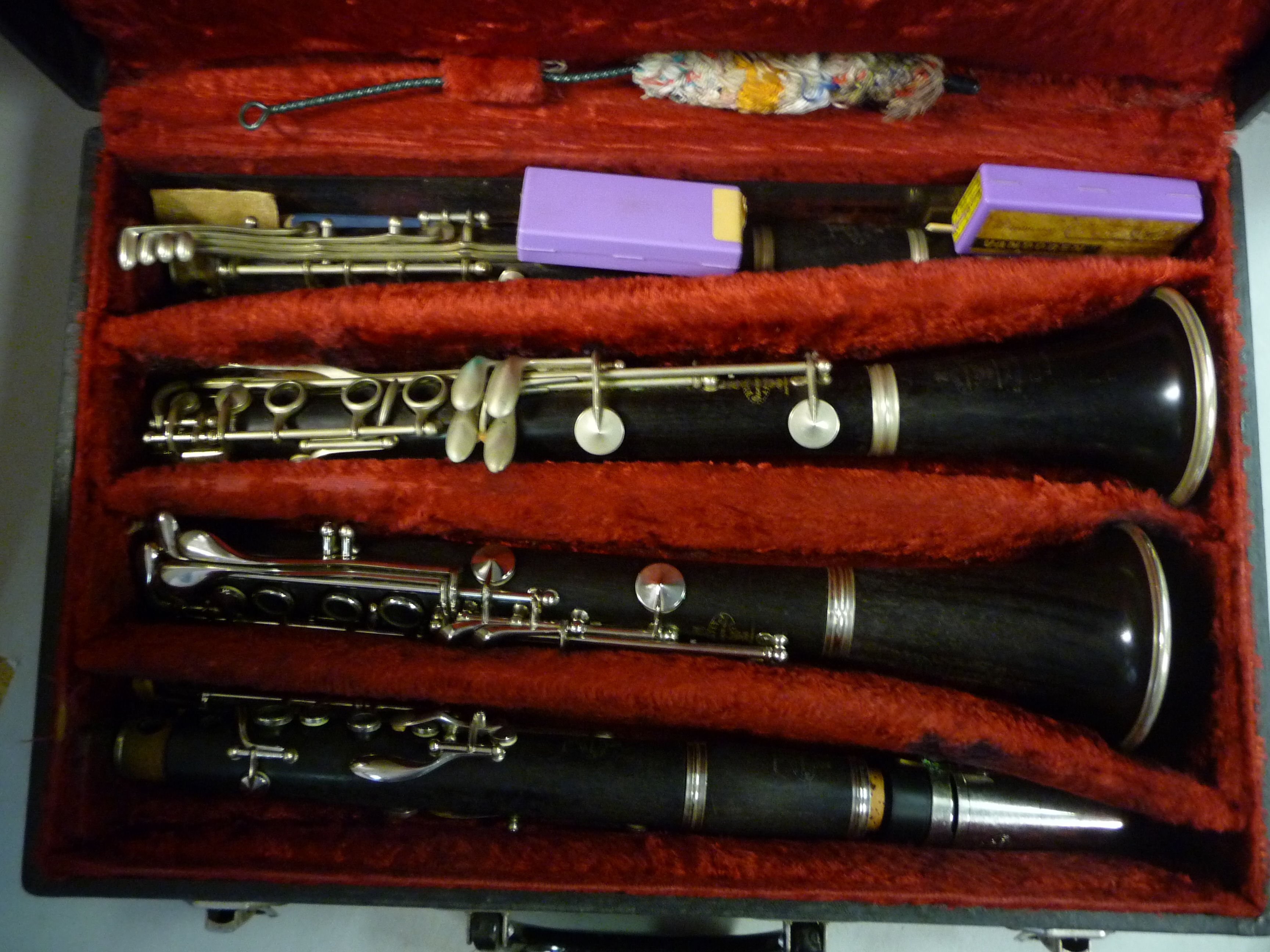 Two Buffet Cramrom & Co clarinets, distributed by Dallas of London, in a fitted maroon fabric lined,