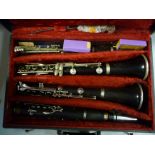 Two Buffet Cramrom & Co clarinets, distributed by Dallas of London, in a fitted maroon fabric lined,