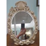 A mid 19thC Western European ivory framed dressing table mirror, set with an oval, bevelled plate,