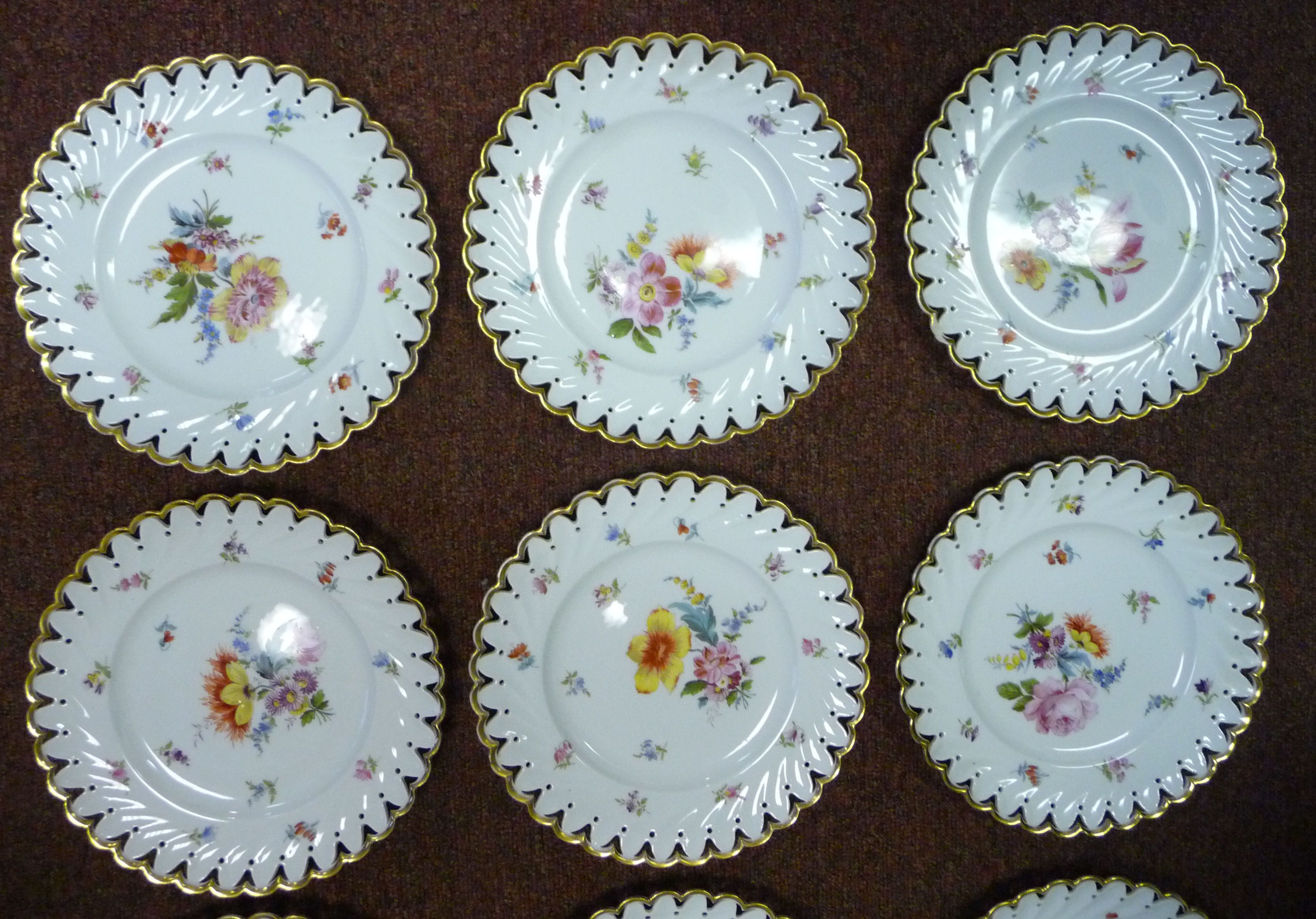 A set of nine early 20thC Continental ivory glazed porcelain dessert plates with thumb moulded, - Image 5 of 11