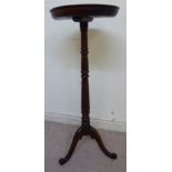 An early/mid 19thC oak torchere, the turned one-piece top with a raised border,