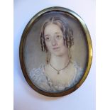 A late 19thC oval, head and shoulders portrait miniature, a woman with her hair in ringlets,