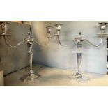 A pair of Edwardian silver two part candelabra of oval, serpentine outline,