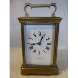 An early 20thC lacquered brass cased carriage clock with straight sides,