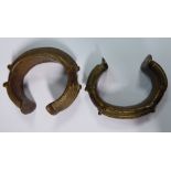 Two similar West African decoratively cast bronze manillas