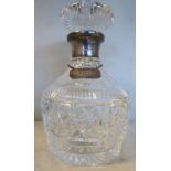 A mallet shaped crystal decanter and flat topped stopper with decoratively cut ornament,