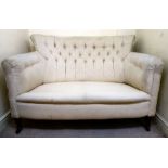 A late Victorian curved boudoir settee with a level back and enclosed arms,