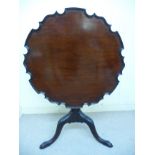 A late Victorian Georgian style mahogany pedestal table, the top with a piecrust border,